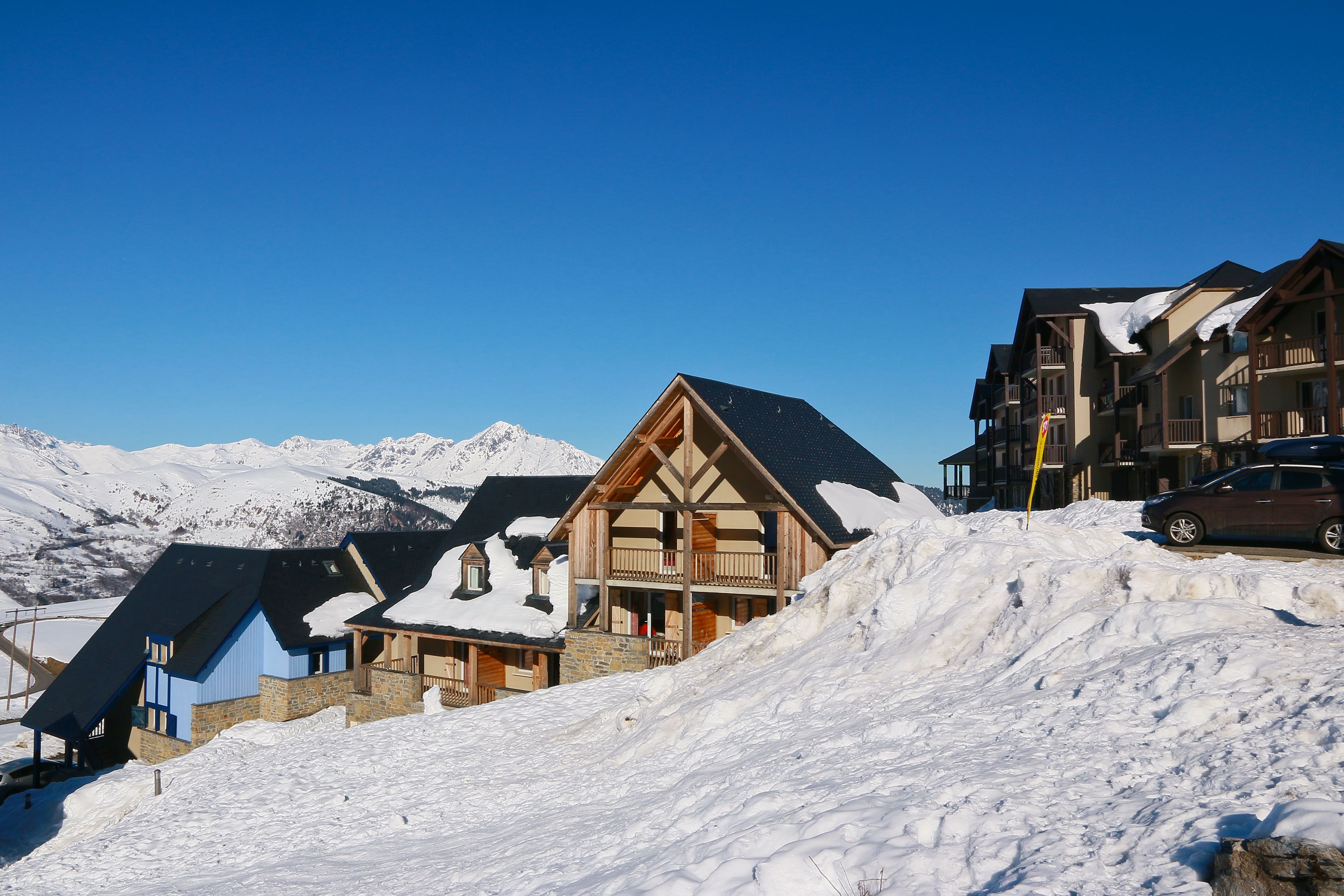 image Row of buildings with snow, and mountains visible in the background