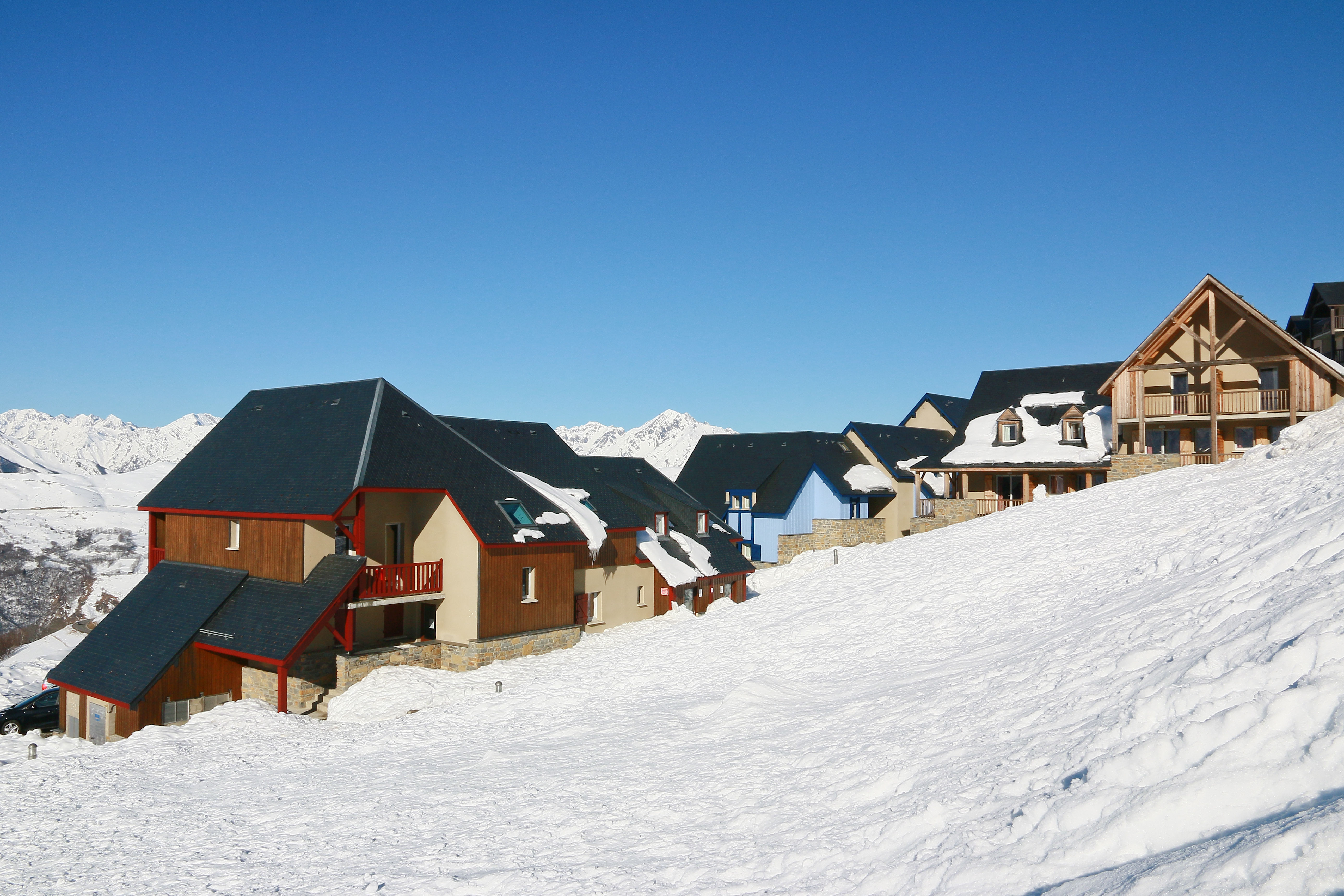 image Row of snow-covered buildings on sloped terrain