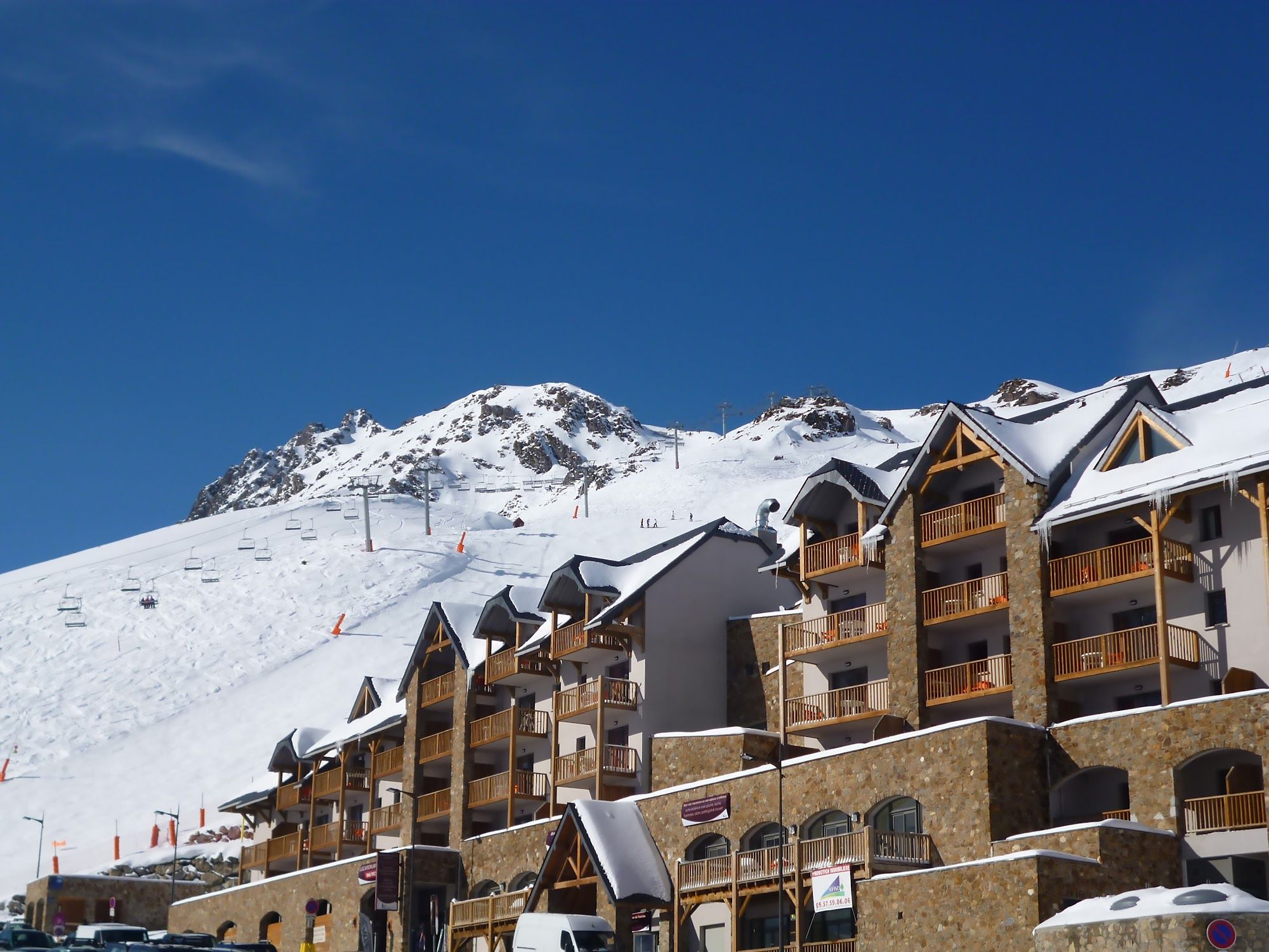 image Mountain scenery with snow, ski lift, and wooden structures