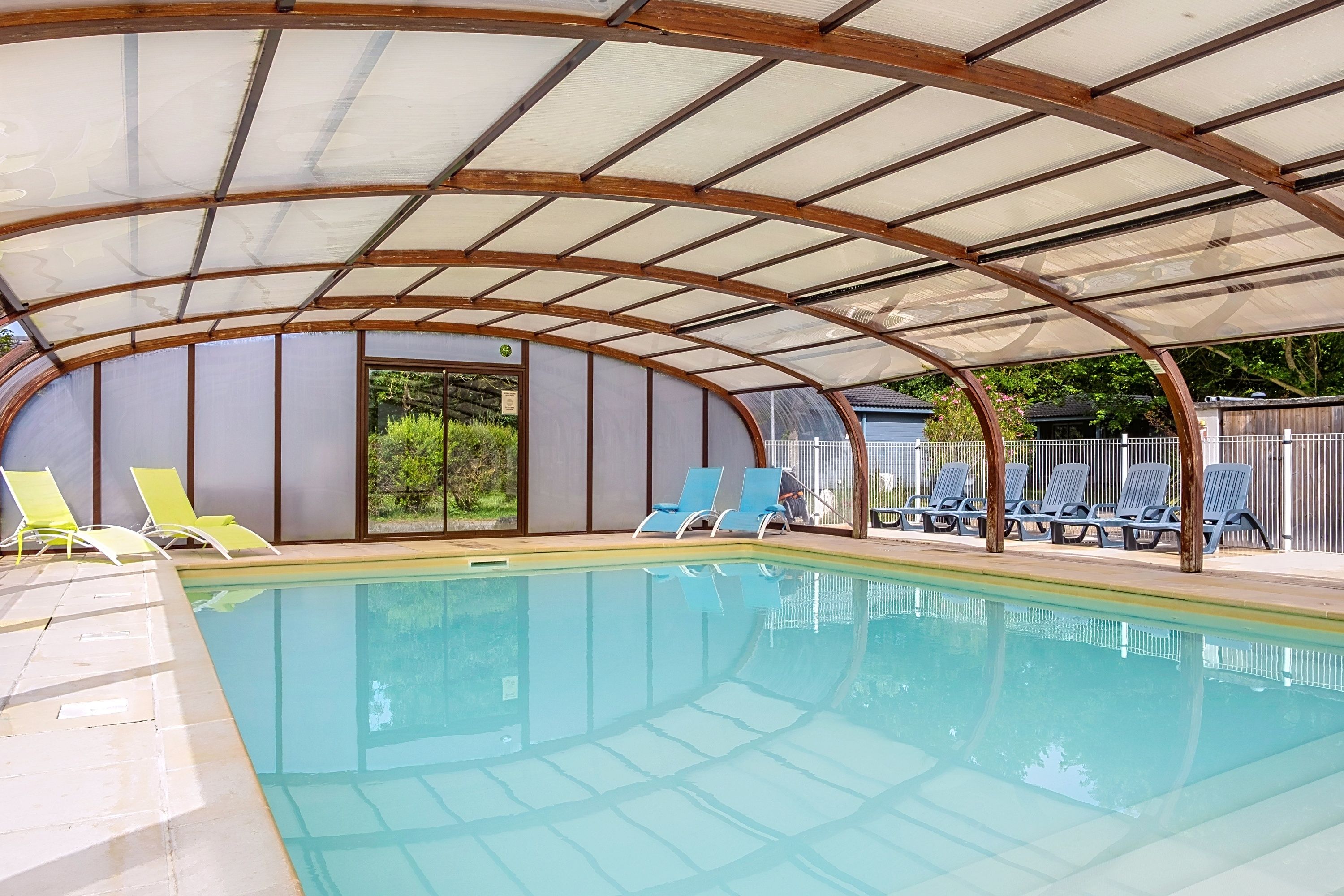image Loungers sit around the indoor pool, its glass roof letting in the daylight.
