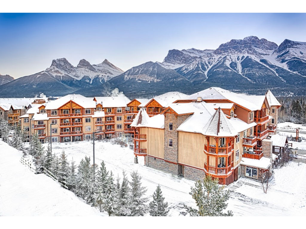 image Nestled in the heart of the Canadian Rockies, this stunning retreat offers cozy elegance surrounded by snow-covered peaks.